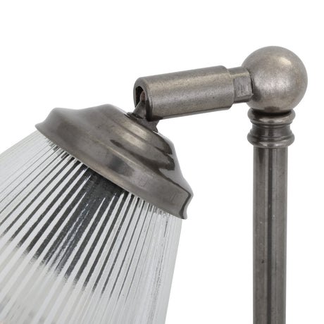 Close-up of the Mirovel ribbed glass table lamp's swivel arm and metal fittings in silver finish, showing the cone-shaped shade joint on a slim stem, plain white background.