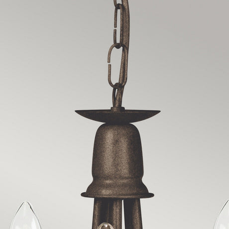 Close-up of the Minster 5 Light Chandelier - Black/Gold Patina, showcasing its rustic finish and chain-link for hanging. The bell-shaped top supports multiple candle-style bulb holders around the edges, making it ideal as a convertible semi-flush fitting against a plain light gray background.