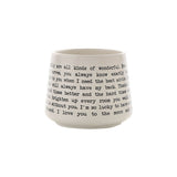 White stoneware mug printed with black typewriter-style script reading a sister message, photographed on a plain white background.