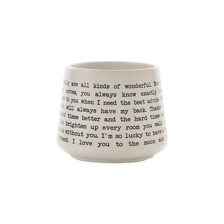 White stoneware mug printed with black typewriter-style script reading a sister message, photographed on a plain white background.
