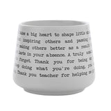 White stoneware mug with a wraparound teacher thank-you quote in black typewriter-style text on a matt white finish, shown on a plain background.