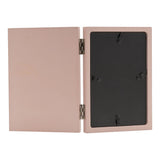 Open hinged wooden photo frame in matt pink, shown from the back with metal hinges and stand clips, on a plain white background.