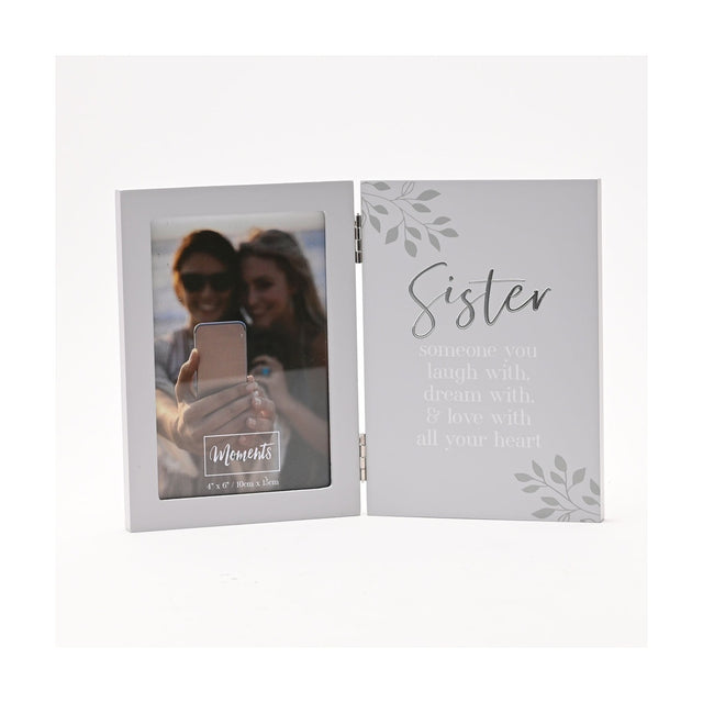 Hinged grey photo frame with a 6 x 4in portrait window on the left and "Sister" verse in silver script and white lettering on the right, shown on a white background.