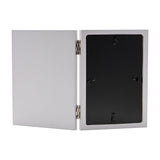 Sister Verse hinged photo frame in grey, shown open with black velvet backing and easel-style metal stands visible, 6 x 4in portrait opening, plain white background.