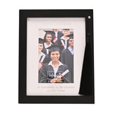 Black wooden Graduation photo frame for 4 x 6in photo, with white mount, serif "Graduation" text, inspirational quote, and black tassel hanging from a silver stud at the top corner.
