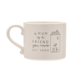 White stoneware mug with looped handle, printed with "a MUM is a FRIEND you never OUT GROW" beside a line-drawn house and flower, set on a plain white background.