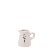 Off-white glazed ceramic mini jug ornament with curved handle and a fine black flower stem sketch on the front, shown on a plain white background.