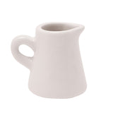 Mini ceramic jug ornament in off-white glaze with a curved handle and pouring spout, shown plain side forward against a white background.