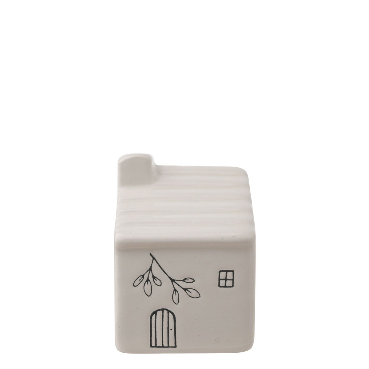 White ceramic mini house ornament with ribbed roof, chimney, four-pane window, arched door, and leaf branch line drawing, on a plain white background.