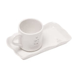 Off-white stoneware mug with rounded handle and heart print "enjoy the LITTLE things", set on a matching wavy-edged rectangular plate, shown on a plain white background.