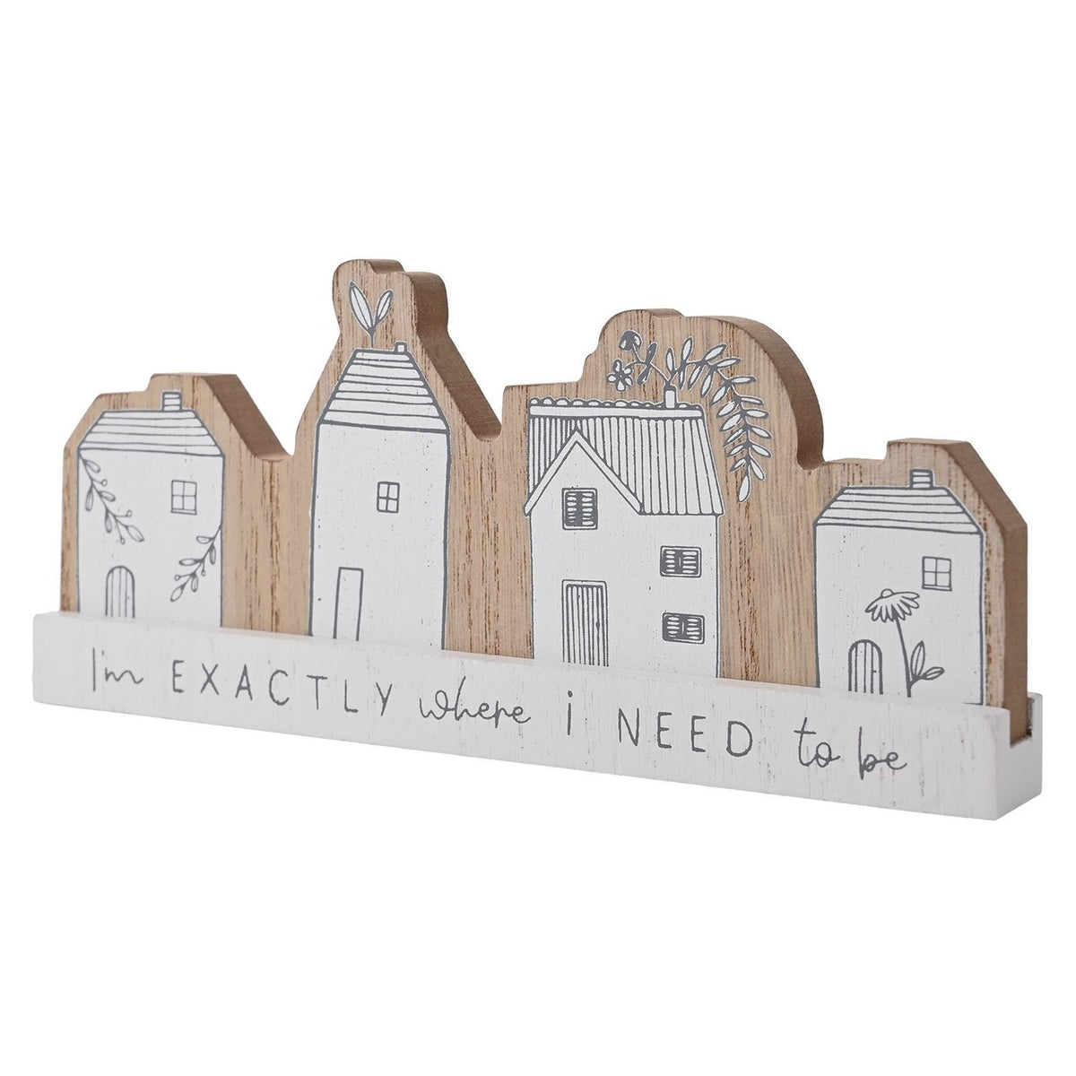 Wooden mantel plaque featuring four white houses with grey linework, pitched roofs and floral details, on a white base reading "I'm EXACTLY where i NEED to be", shown on a plain background.