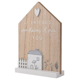 House-shaped wooden wall plaque with a white heart accent and If Friends were flowers id pick You lettering, featuring a white cottage and picket fence base on a stand, plain background.