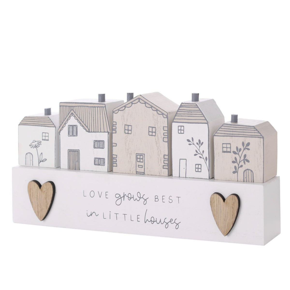 Wooden plaque with five white and beige houses, grey line details, chimneys, wood-toned hearts, and the text Love grows best in little houses on a plain background.