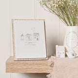 Little Houses Layered Wooden Plaque with Easel Stand in grey, showing three line-drawn houses and hearts above the text "Love grows best in little houses," displayed on a wooden shelf.