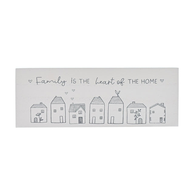 White wooden mantel plaque reading "Family is the heart of the home" in grey script, above a row of seven line-drawn houses with hearts and floral details.