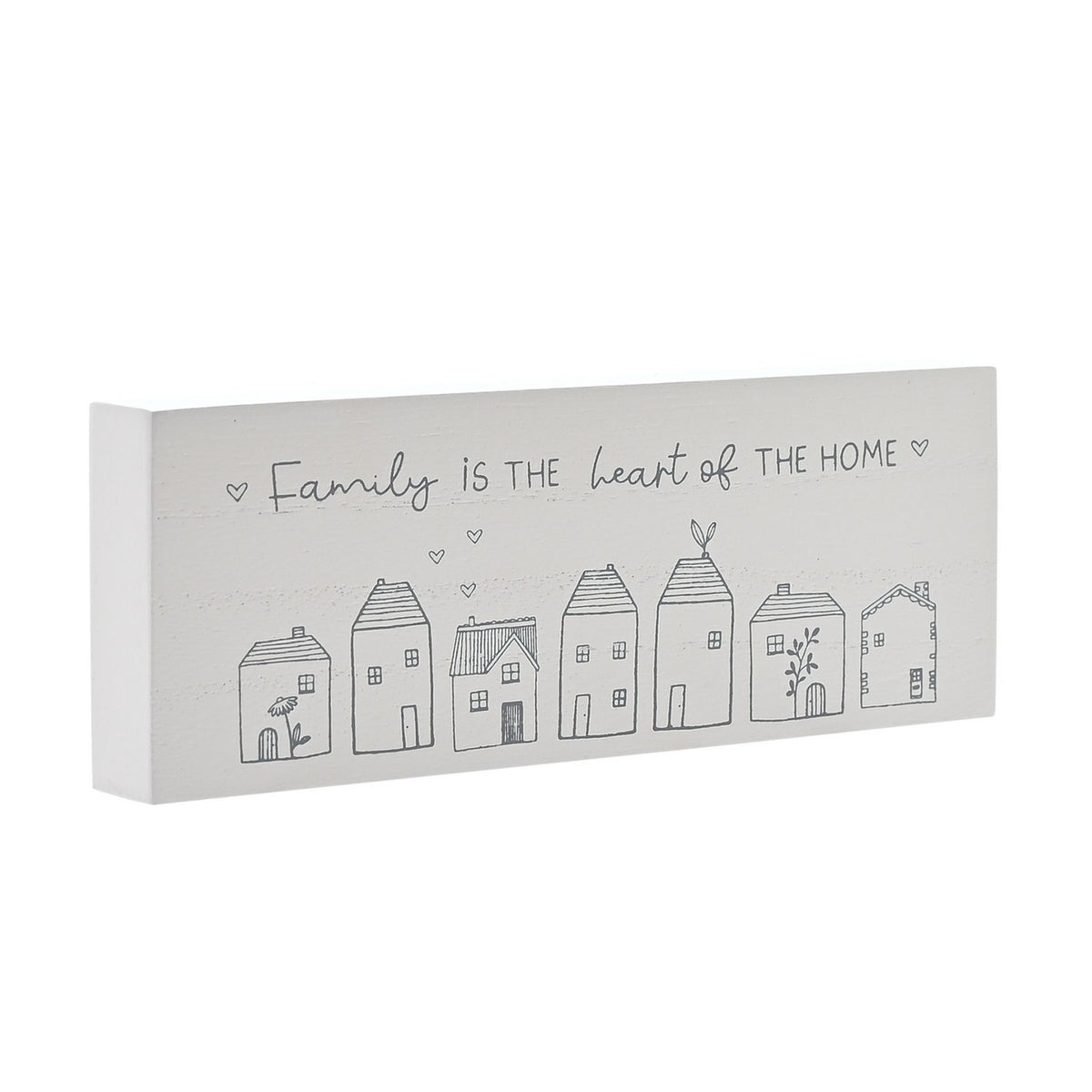White wooden mantel plaque reading "Family is the heart of the home" in grey script above a row of seven line-drawn houses, shown at an angle on a plain background.