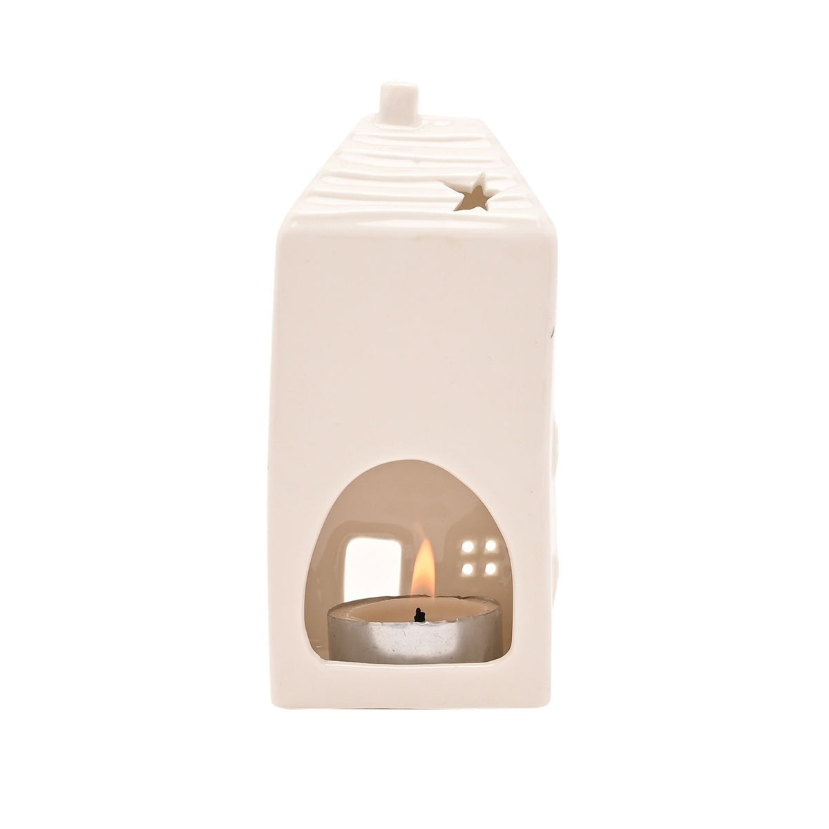 White ceramic house-shaped tea light candle holder with ridged roof, chimney, star cut-out, and arched front opening revealing a lit tea light, shown on a plain white background.