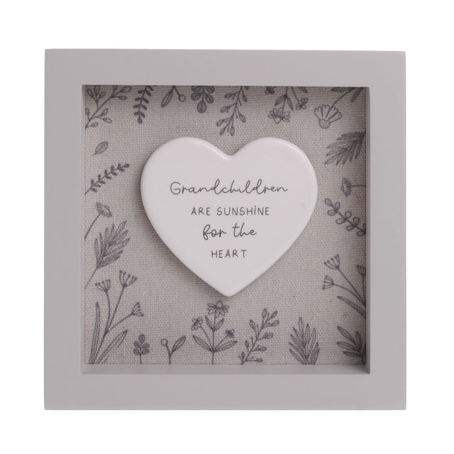 Square off white wooden framed plaque, 15cm x 15cm, with a white heart centred on a grey floral linen-look background, reading "Grandchildren are sunshine for the heart".