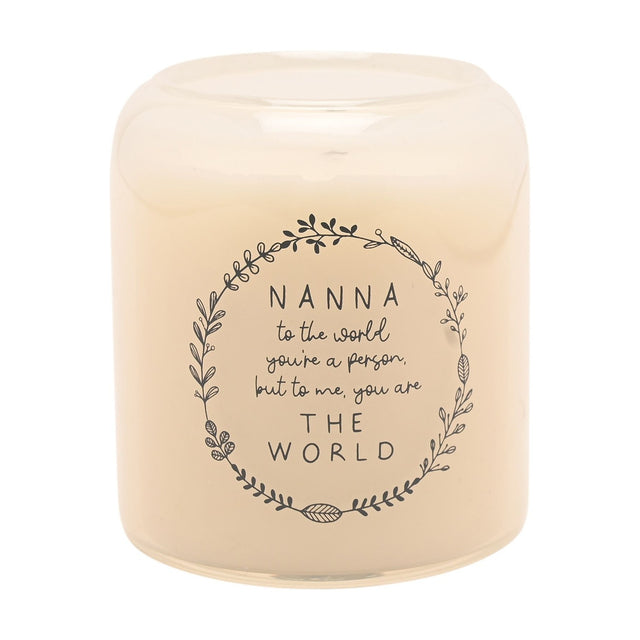 Round cream scented candle in a glass jar, printed with a grey leafy wreath and "Nanna to the world... THE WORLD" sentiment, on a plain white background.