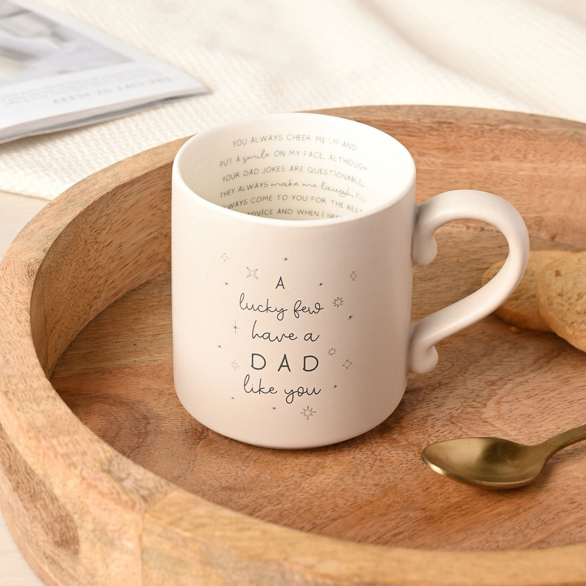 Cream 400ml mug reading "A lucky few have a DAD like you" with star details, plus printed inner message, shown in a wooden tray with a spoon and biscuit.