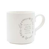 Cream mug with handle, featuring a grey floral wreath line drawing framing "FAMILY where life begins and LOVE never ends" text, shown on a plain white background.