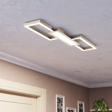 Monirote LED flush ceiling light in brushed aluminium with two open rectangular frames flanking a central panel, mounted on a textured ceiling in a hallway setting.