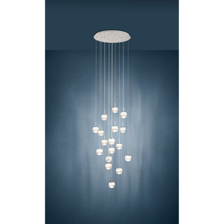 Montefio 2 Glass 17 Light Pendant in chrome, round ceiling plate with clear glass globes cascading at varied lengths, shown against a dark blue wall.