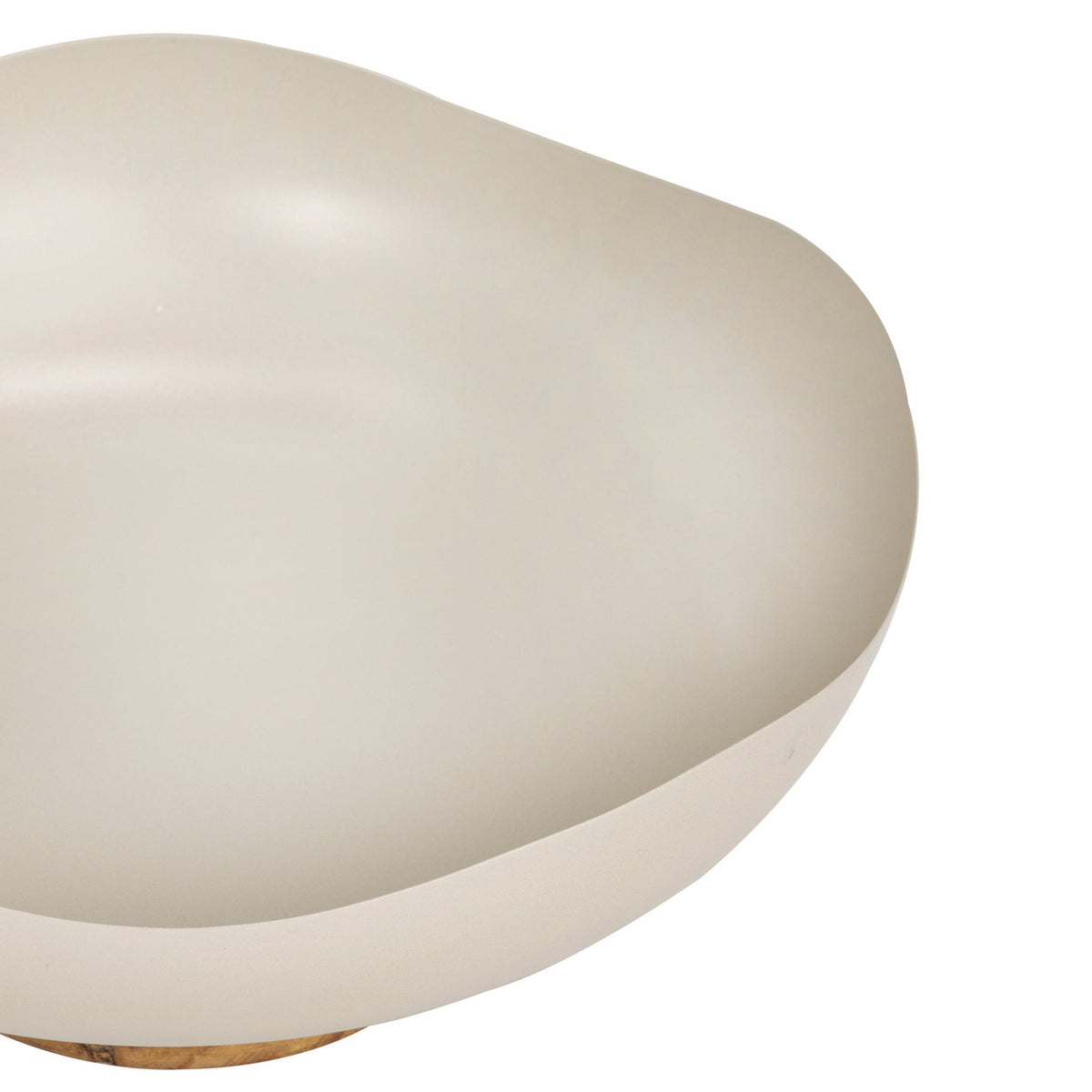 Close-up of the Monywa decorative bowl in matte cream metal with a gently wavy organic rim, shown on a short wooden pedestal foot against a plain white background.