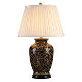 The Morris 1 Light Large Table Lamp - Gold & Black features an intricate black and gold ceramic base adorned with a gold floral pattern that evokes the elegance of Chinese porcelain, complemented by a generously sized pleated white lampshade that casts a warm, soft glow.