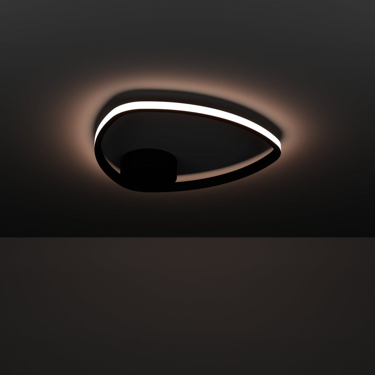 Moschella LED Flush Ceiling Light in black, a slim rounded-triangle ring with a glowing white diffuser edge and round black canopy, shown illuminated against a dark background.