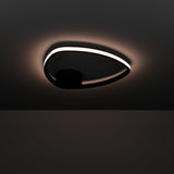 Moschella LED Flush Ceiling Light in black, a slim rounded-triangle ring with a glowing white diffuser edge and round black canopy, shown illuminated against a dark background.