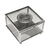 Square glass trinket box with slim silver metal frame and a round silver metal badge on the lid reading "18th Birthday," shown on a white background.