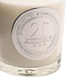 Close-up of the 21st Birthday Sandalwood Scented Candle in cream wax with a round silver medallion reading "21st Birthday" and three stars, bordered by a years-to-days countdown.