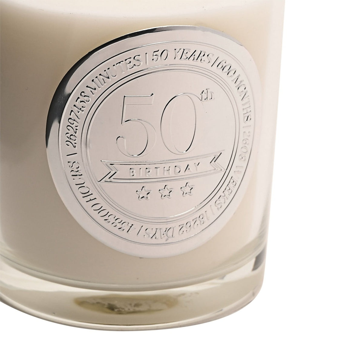 Close-up of the 50th Birthday Sandalwood Scented Candle in a clear glass jar with a round silver medallion engraved "50th Birthday" and time milestones, set against a white background.