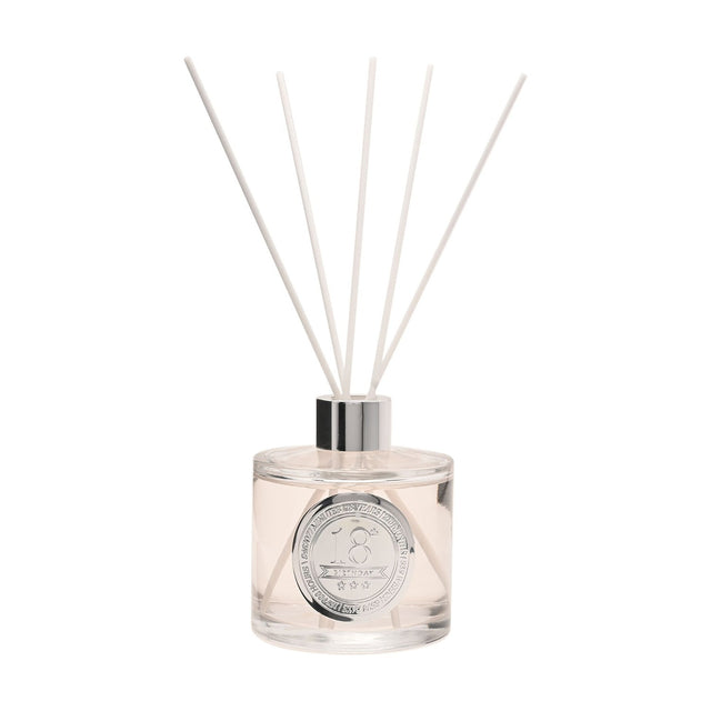 18th Birthday Sandalwood Reed Diffuser, round clear 200ml bottle with pale blush liquid, silver collar and white reeds, set on a plain white background.