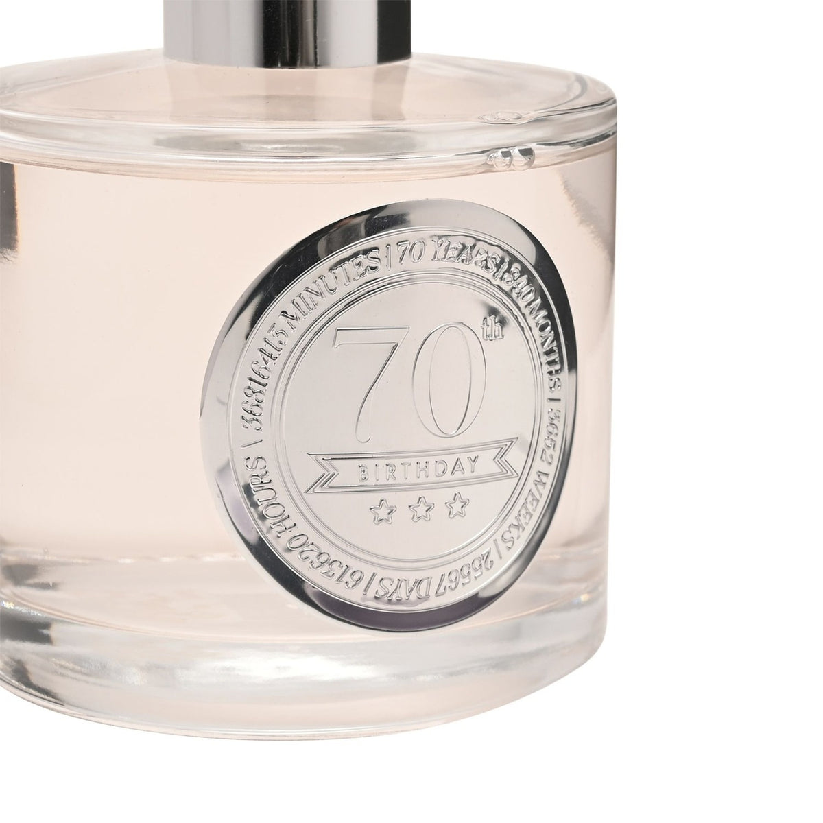 Close-up of the 70th Birthday Sandalwood Reed Diffuser 200ml, clear glass bottle with silver cap and round silver medallion marking 70 years, on a white background.