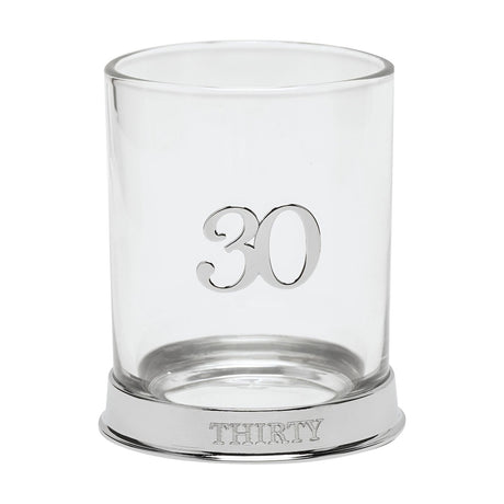 Round glass whisky tumbler with a raised 3D silver "30" on the side and "THIRTY" engraved on its silver base, shown on a plain white background.