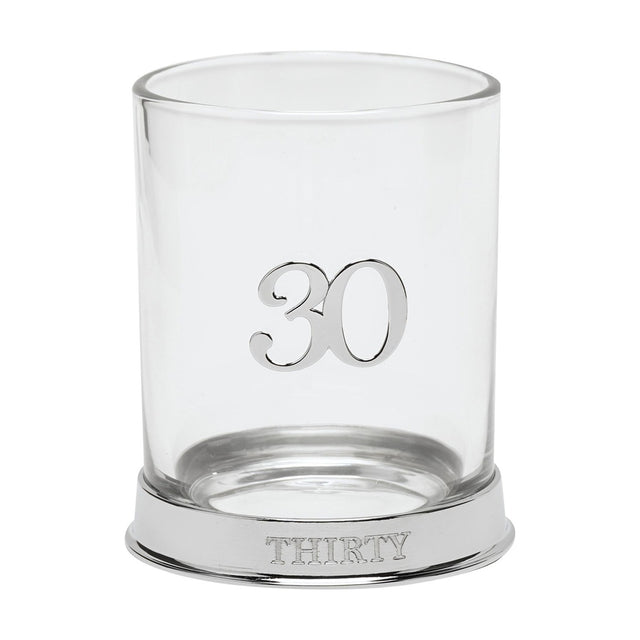 Round glass whisky tumbler with a raised 3D silver "30" on the side and "THIRTY" engraved on its silver base, shown on a plain white background.