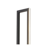 A close-up of the Mural LED Floor Lamp 48W 3000K in matt black shows its slim, modern metal frame against a white background. One edge is softly illuminated, emphasizing its contemporary lighting design.