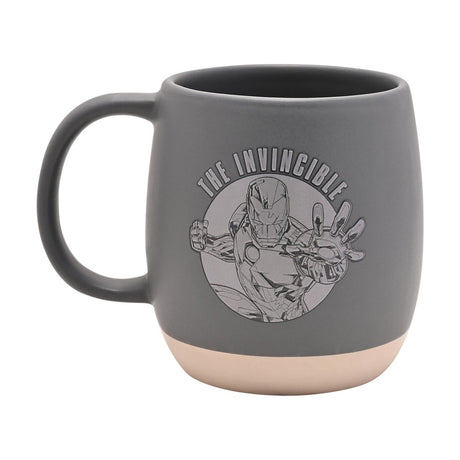 Matte grey ceramic mug with cream base band, featuring a line-drawn Iron Man graphic and "THE INVINCIBLE" text, rounded handle, shown on a white background.