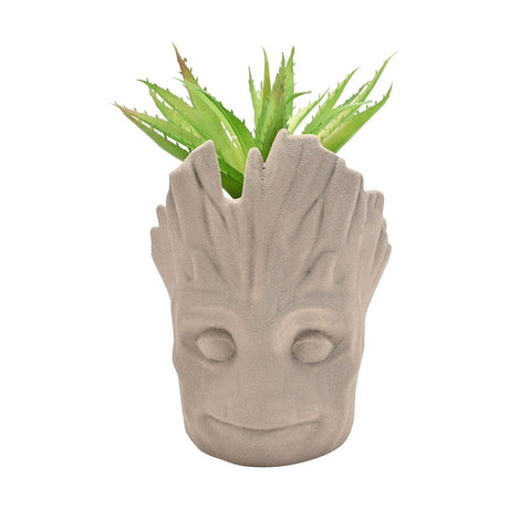 Smiling Groot Head Ceramic Planter in grey, with a sculpted bark-textured face and matt finish, holding a faux spiky green plant, shown on a plain white background.
