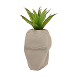 Iron Man helmet-shaped metal planter in matt cement grey with raised facial detailing, planted with a spiky green faux plant, shown on a plain white background.