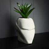 Iron Man Helmet planter in matt cement grey metal with raised brow and faceplate detail, holding a spiky faux plant on a dark surface.