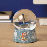 Resin snow globe with Thor's silver hammer and blue glitter inside a round glass dome, on a blue-grey base reading "THOR" with lightning graphics, displayed on a desk.