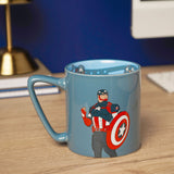 Blue porcelain mug with slate blue glaze featuring Captain America raising a fist beside his shield, light blue interior with printed decal, shown on a desk.