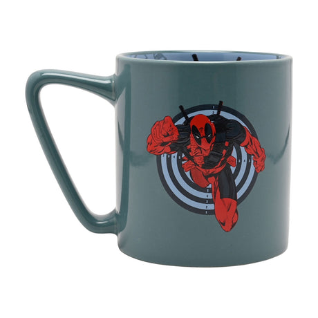 Green porcelain mug with a C-shaped handle, featuring a printed Deadpool graphic leaping from a numbered target design, with a pale blue decal visible inside the rim, on a plain white background.