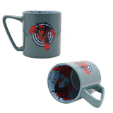 Green porcelain mug with Deadpool leaping from a target design on the outside and a pale blue interior printed with a matching Deadpool decal, shown front and inside view on a white background.