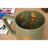 Green porcelain Groot mug with glossy finish, shown from above revealing an inside decal of Groot figures amid swirling vine patterns.