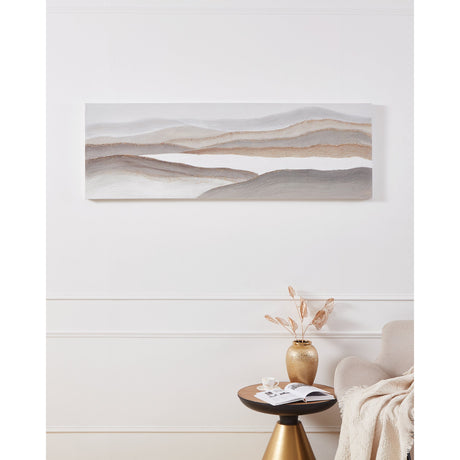 Nambu Wall Art, a long landscape canvas of layered grey, beige and white hills with gold-flecked ridges, hung above a side table with a vase and armchair in a neutral room.