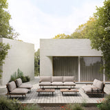 Nami 3 Seater Garden Sofa with beige cushions on an aluminium and iroko wood frame, shown on a wooden terrace with matching coffee tables and armchairs.